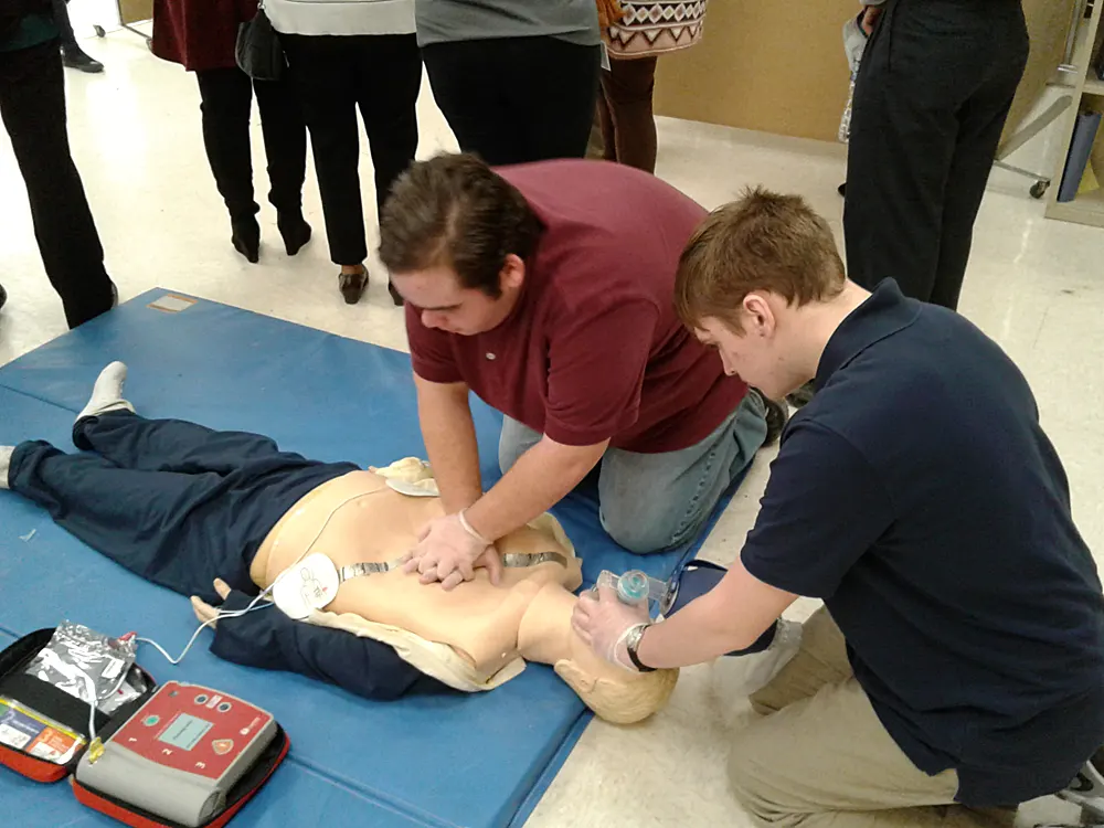 Students practice CPR on a dummy