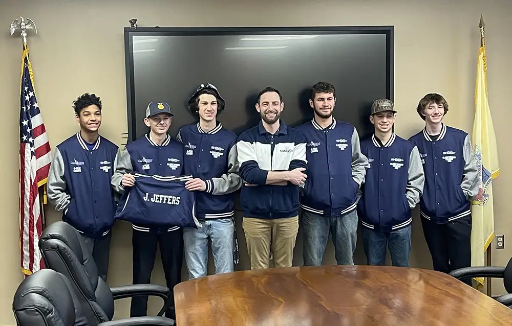 SCVTS Boys Cross Country team lining up for a picture in blue jackets